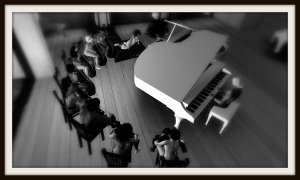 VBCO cast members playing cellos and circling piano players Pixel Reanimator and Gina Broono