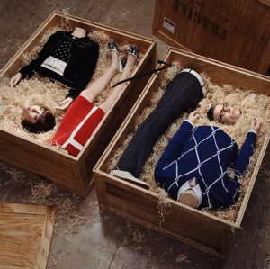 Hugh Kretschmer's 2006 photograph "Special Delivery" depicting 2 people in parts in shipping crates and wearing stylish apparel.