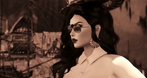 selenium toned headshot of Agnes Sharple wearing sunglasses and a white shirt