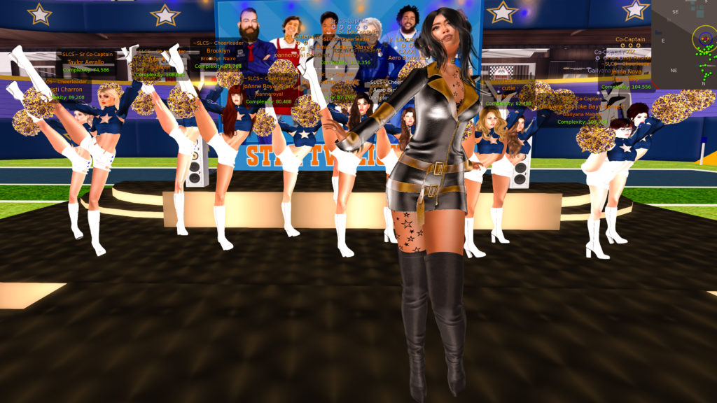 Vocalist Star Twilighton singing on stage in Skytower Stadium and with the Second Life Cheerleading Squad dancing behind her.
