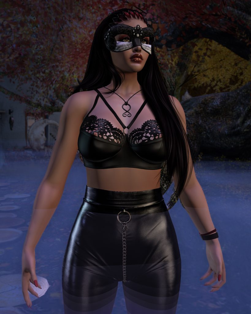 Kate Nova wears a black bra and shiny leggings. She stands in a dark bog at New Moon Cottage in the virtual world of Second Life